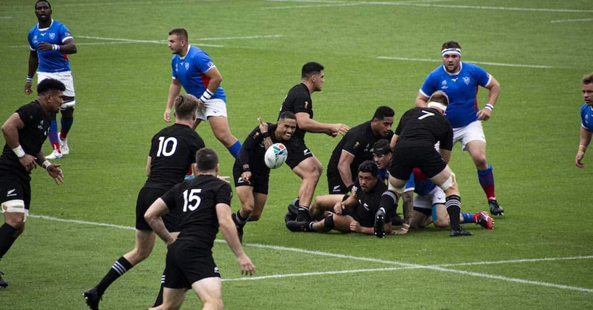 Rugby sport played by two teams wearing red and blue.