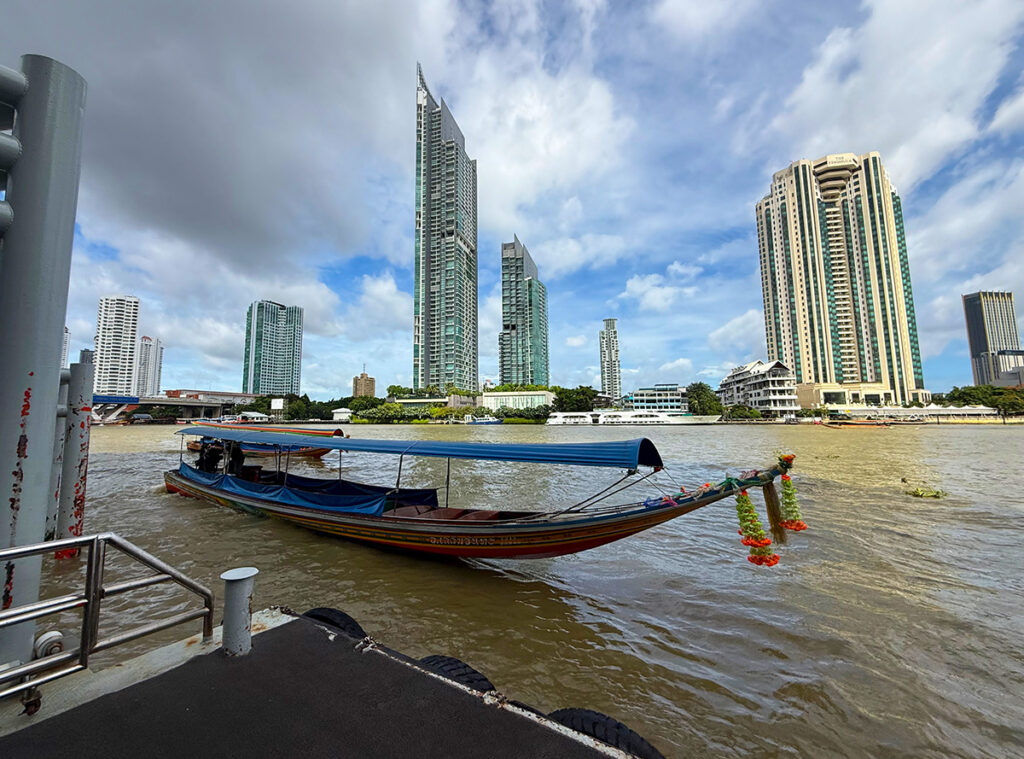 Our long boat arrives at the Shangri La pier
